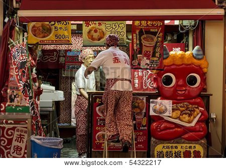 Employees Closing A Street Bar In Dotombori, Osaka, Japan