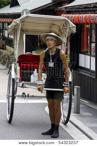 A Traditionaljapanese Rickshaw In Arashiyama District