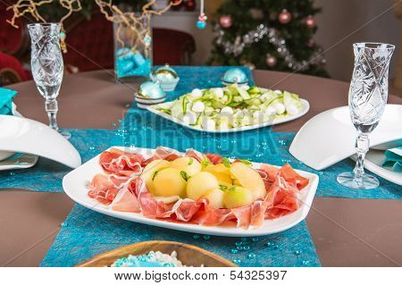 Holiday-decorated Table, Christmas Tree, Ham And Melone, And Salad