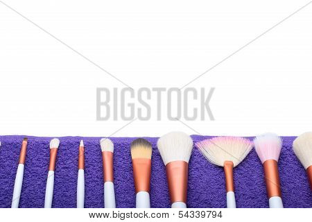 Makeup Brushes set on purple towel