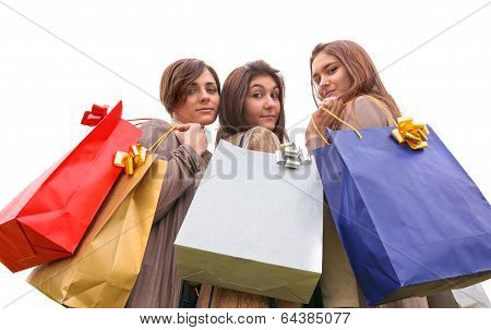 three happy girls doing shopping