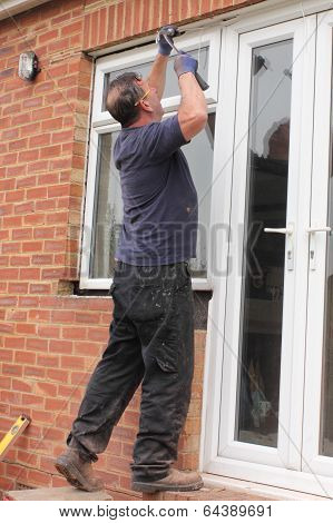 A Window fitter removing old windows