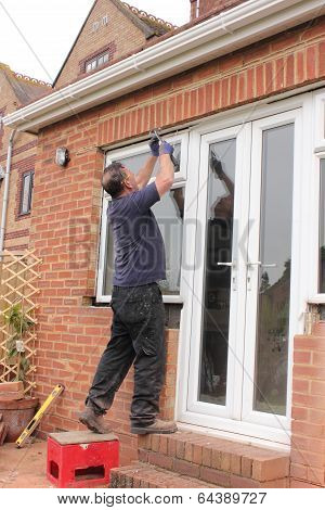 A Window fitter removing old windows