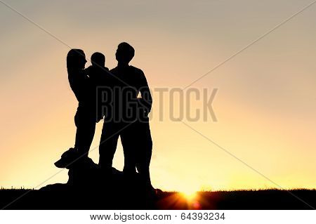 Happy Young Family And Dog Silhouette At Sunset