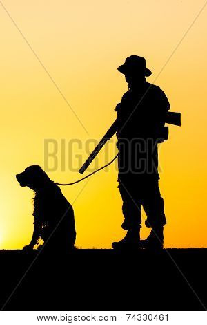 Silhouette of the hunter with a dog