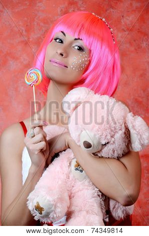 woman laughing with candy and beautiful make-up  whith taddy bear