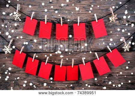 Red Tags With Copy Space Hanging In The Snow On Wooden Background