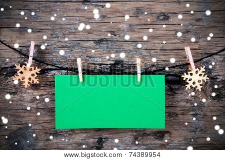 Empty Green Label With Snow On Wooden Background