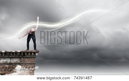 Young guy in casual evading from light rays