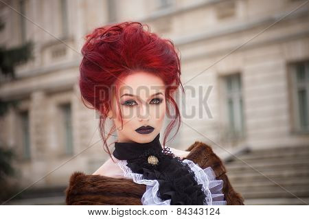 sexy woman with gothic makeup and red hair and castle