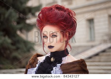 sexy woman with gothic makeup and red hair and castle