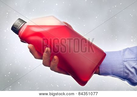 Hand Holding A Bottle Of Antifreeze