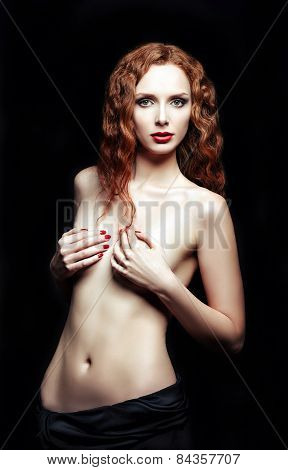 Studio Portrait Of Sexy Red-haired Woman On Black Background