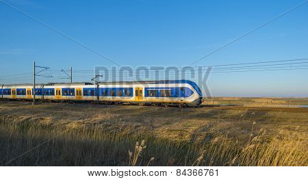 Train moving through the countryside in winter