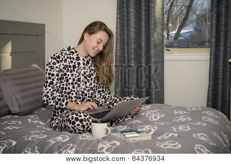 Teenager In Bed with a computer