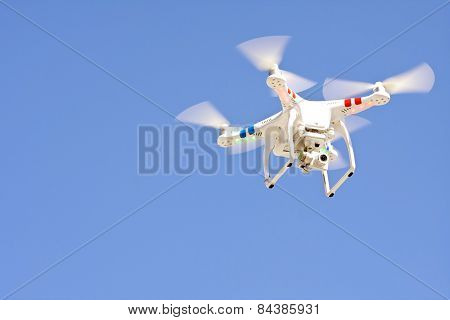 Drone Hovers Isolated Against Blue Sky
