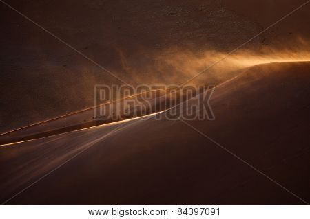 Sand blowing off the top of a dune in Sossusvlei