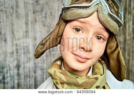 Close-up portrait of a happy kid who dreams of becoming a pilot. Childhood. Fantasy, imagination. 