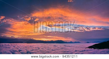 Bright and colorful sunset over the sea of clouds.