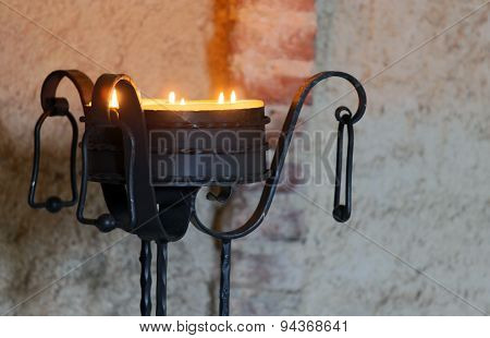 ancient iron candelabrum to illuminate the Interior of the medieval castle