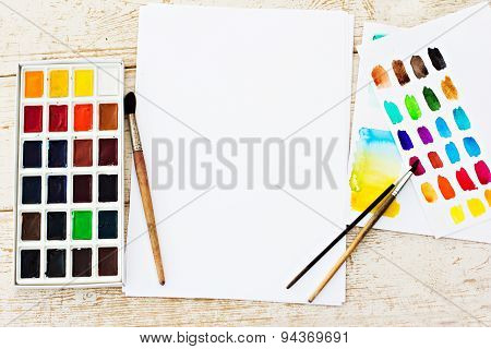 Workplace artist - paper paint brushes color wheel