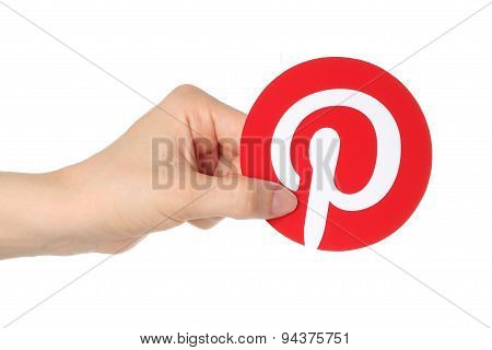 KIEV UKRAINE - APRIL 30 2015:Hand holds Pinterest logotype