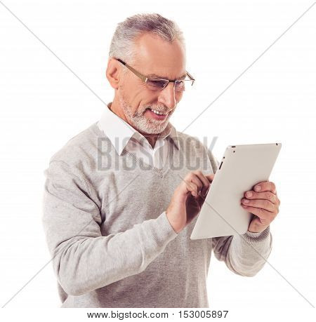 Handsome mature businessman in smart casual wear and eyeglasses is using a digital tablet and smiling isolated on white