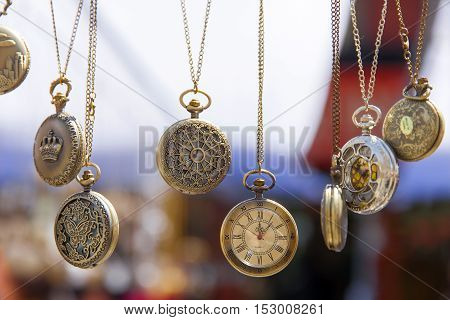 Many vintage pretty watches hanging. Antique look.