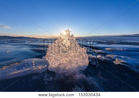 Sun At Sunset Shining Through The Transparent Texture Of The Ice Floe In Lake Baikal