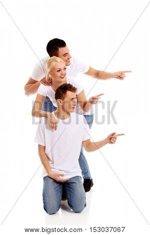 Group of happy people pointing for something