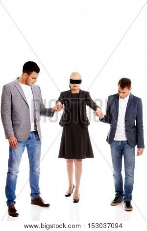 Business team-two men helping to blindfolded woman