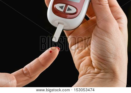 Blood sugar testing with portable glaucometer, color image
