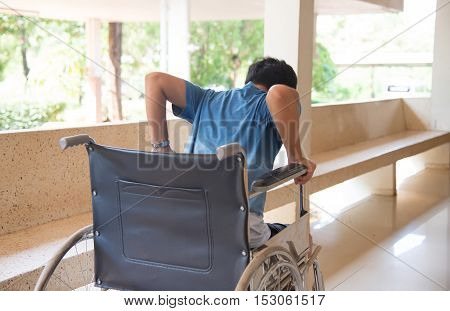 patient in wheelchair parked in hospital with selective focus.