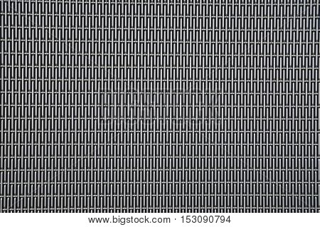 Background sheet of metal covered with abstract lines of holes