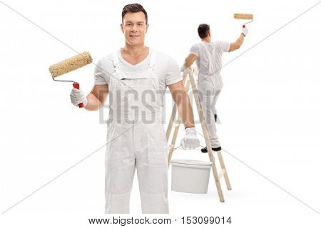 Painter holding a paint roller and a color bucket with another painter painting climbed up a ladder isolated on white background