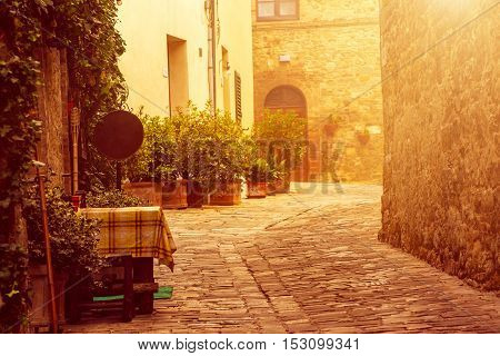 Empty street of small Tuscany town San Quirico d'Orcia with sun shine, romantic travel vintage hipster european italy background
