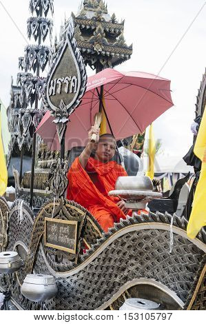 Suratthani, Thailand - October 20, 2016: Buddhist monk sitting on ornamented carriers to be pulled across the city during the famous Chak Phra Festival, an annual Buddhist festival to celebrate the return of Buddha from heaven to earth after the end of th