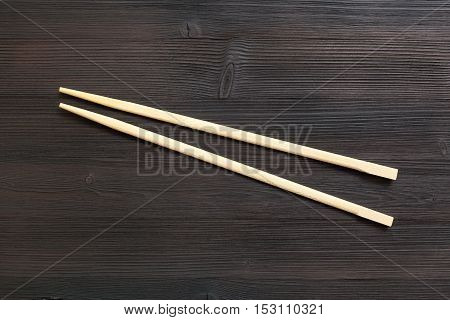 Wooden Disposable Chopsticks On Dark Brown Table