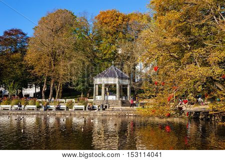 STAVANGER, NORWAY - OCTOBER 14, 2016: People relaxing in City Park on a beautiful autumn day in Stavanger. Stavanger is one of most famous cruise travel destinations in Europe.