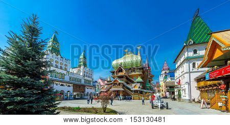 MOSCOW RUSSIA - MAY 10 2015: Izmailovsky Kremlin boasts wooden Tsar's Palace with great dome and scenic fortress gate decorated with bright green towers on May 10 in Moscow.