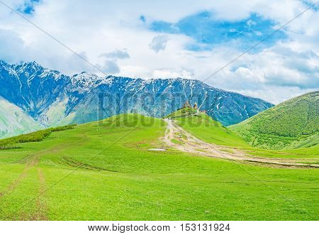 The Gergeti Trinity Church is the visit card of Kazbegi (Stepantsminda) resort and one of the most interesting local religious and historic landmarks Kazbegi National Park Georgia.