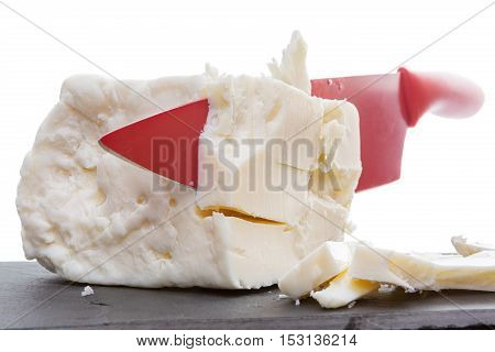 Red Ceramic Knife Slicing Through Feta Cheese