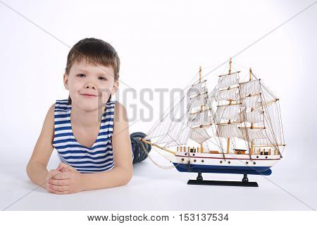 photo of little boy with ship on white