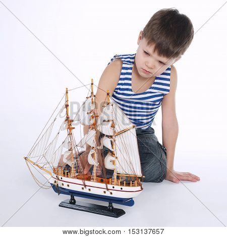 photo of little boy with ship on white
