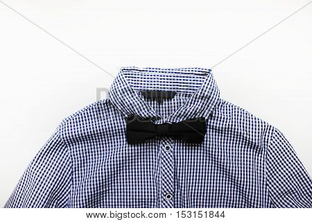 Plaid white and blue shirt with black bow tie close up isolated. Official fashion clothes detail stylish man guy look with empty background for text