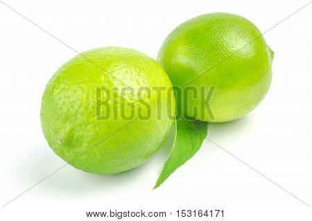 Two lime with leaf isolated on white background.