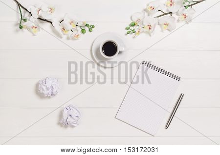Feminine, elegant woman's white, wooden table, desk or workspace seen from above. Top view background with copy space. Creative workspace for freelance girl working from home