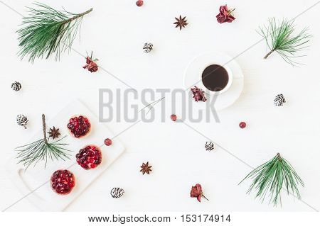 Christmas composition. Cup of coffee christmas dessert anise star pine branches. Flat lay top view