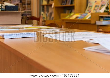 Image of workplace with focus on papers and pen on the table