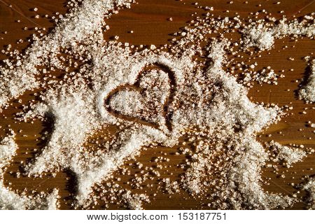 heart of sugar on a wooden background in sunlight. declaration of love